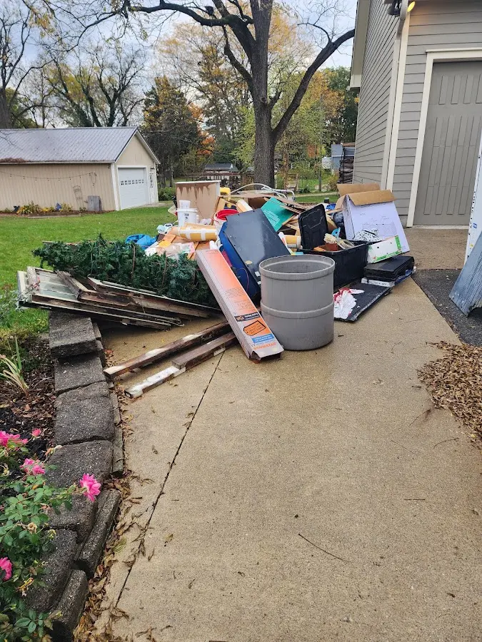 Dumpster being loaded with debris for Estate Cleanout Dumpster Rental in Shreveport